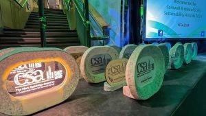 Photograph of Cornwall Sustainability Awards on a table with a screen in the background