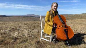 Musician Sarah Smout on Fleet Moss with her cello