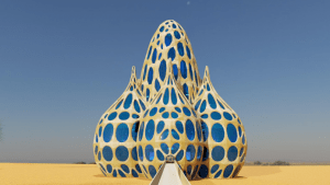 Exterior view of Virtual Peatland Pavilion showing four large domes in a desert landscape