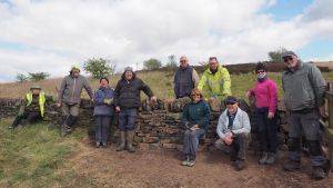Volunteer group with newly built dry stone wall