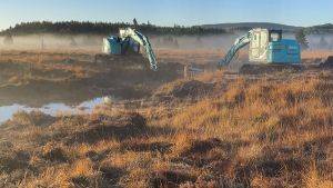 Image of machinery being used on a peatland to restore the habitat