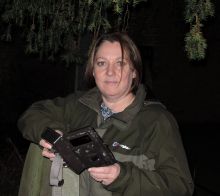 Picture of Rose holding a camera trap at night