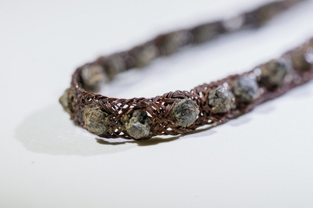 Tin-studded armband or bracelet found at Whitehorse Hill archaeological site.